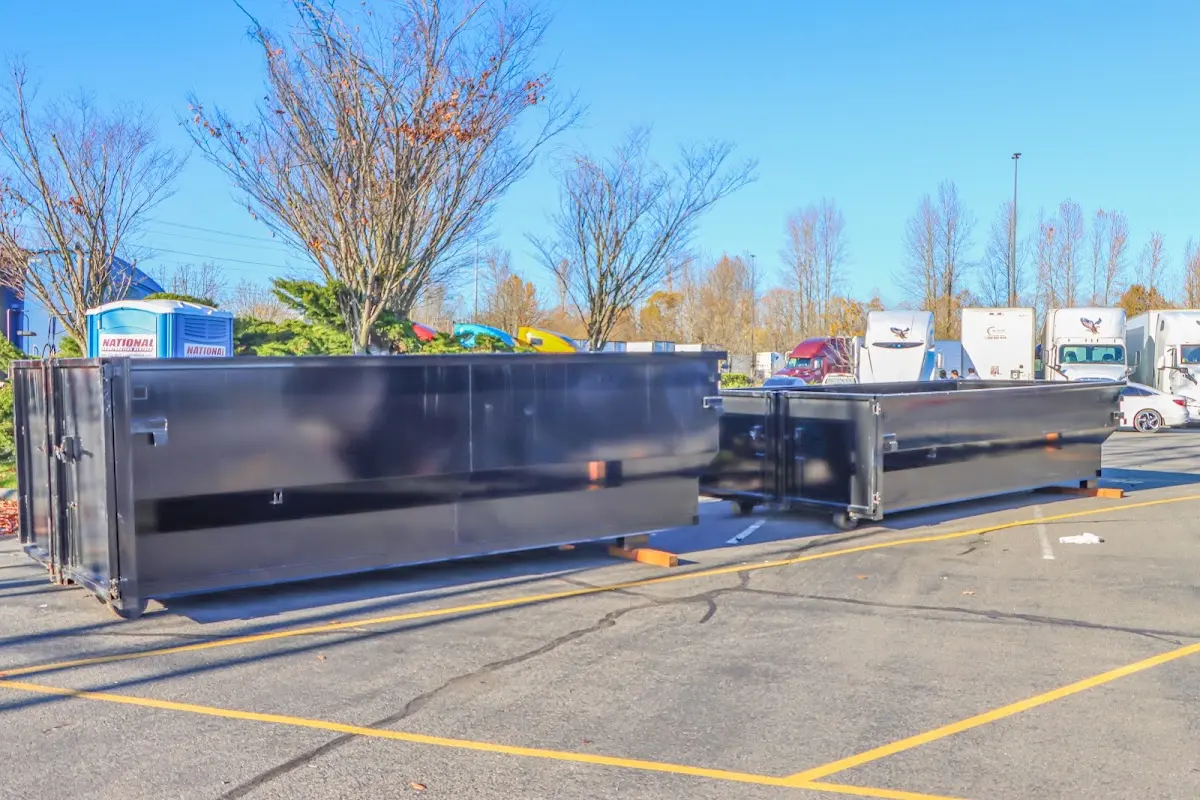 Professional dumpster rental service with roll-off container on residential driveway in Rahway